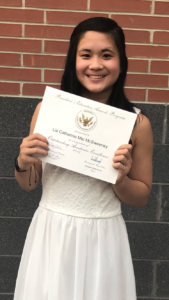 Lia Holding her Presidential Award in Middle School